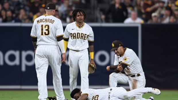Jul 7, 2022; San Diego, California, USA; San Diego Padres shortstop baseman C.J. Abrams (top, center) and left fielder Jurickson Profar (bottom) react after colliding during the fifth inning against the San Francisco Giants at Petco Park. Mandatory Credit: Orlando Ramirez-USA TODAY Sports